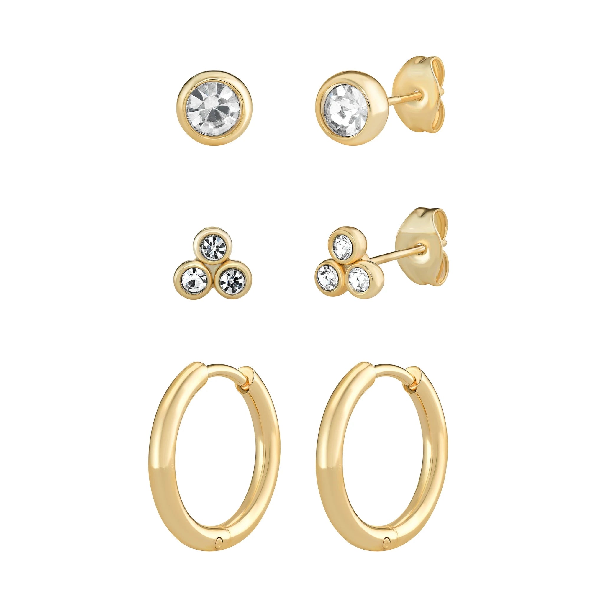 Set of gold earrings with clear gemstones on a white background