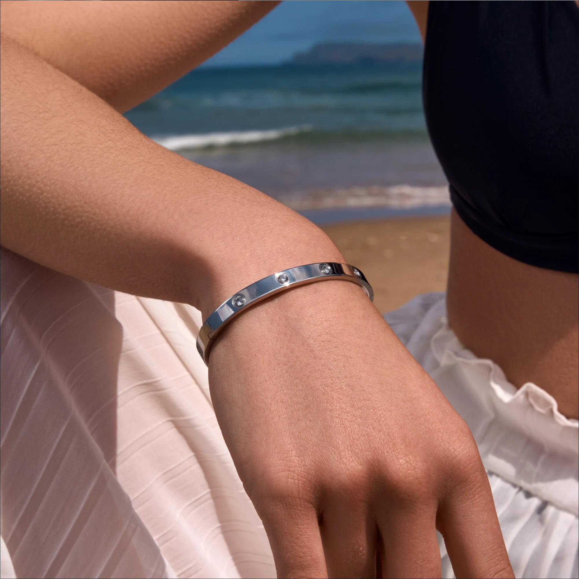 stainless-steel-waterproof-silver-cz-bangle-close-up-on-model